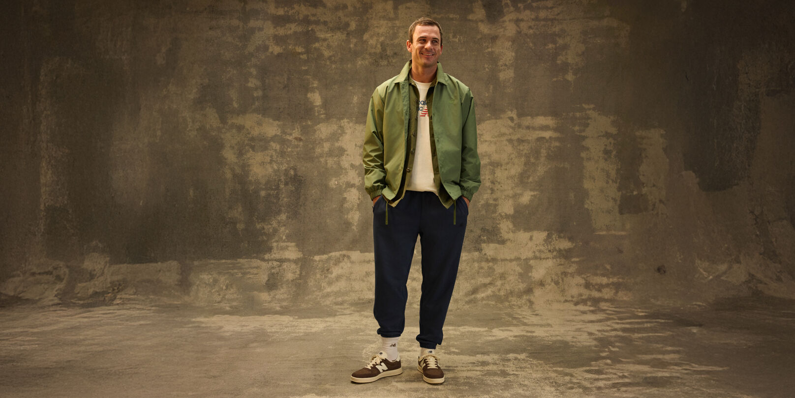 Tommy Paul standing in front of a grungy studio backdrop. 